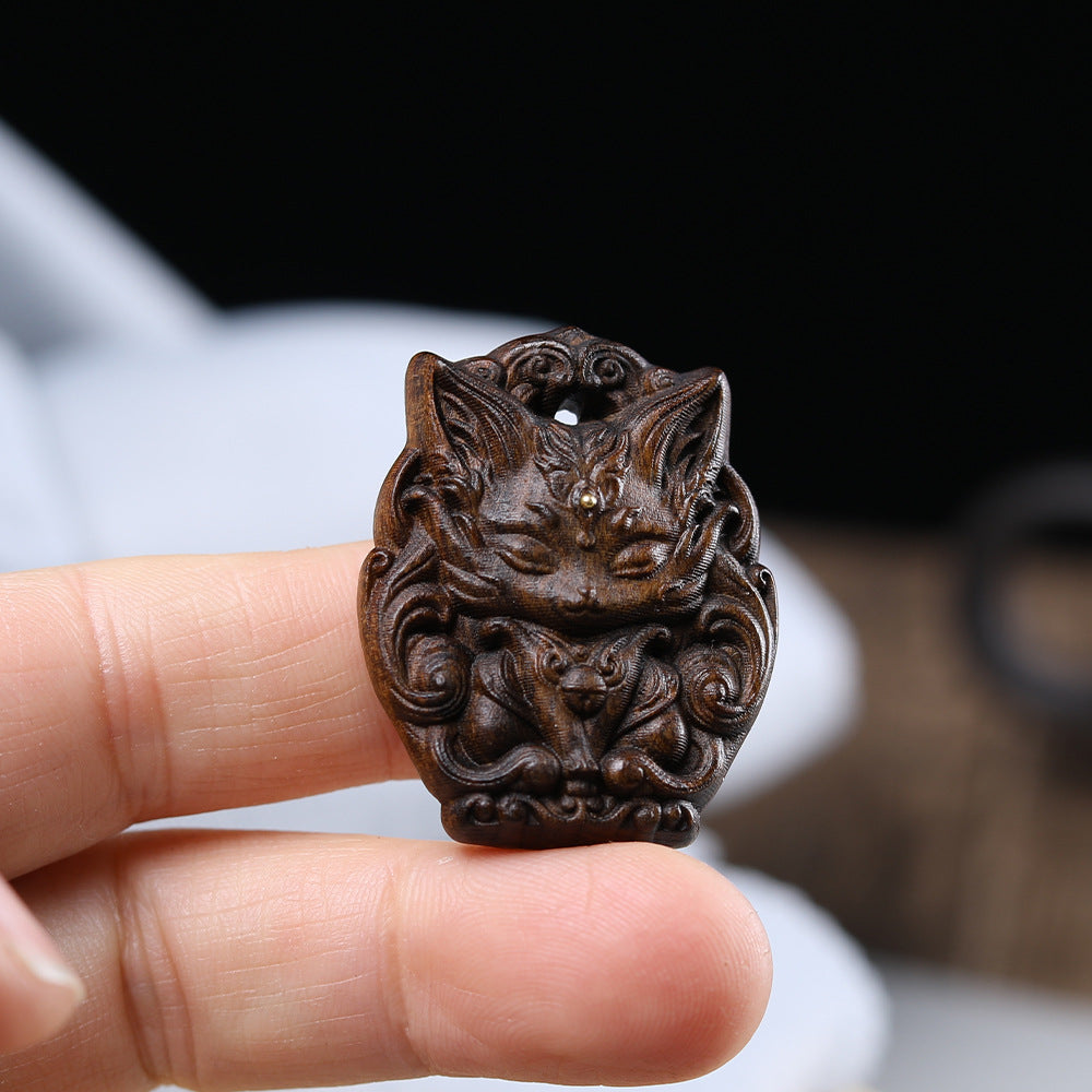 - Hand-Carved Agarwood Nine-Tailed Fox Pendant - Unique Mythical Jewelry Accessory